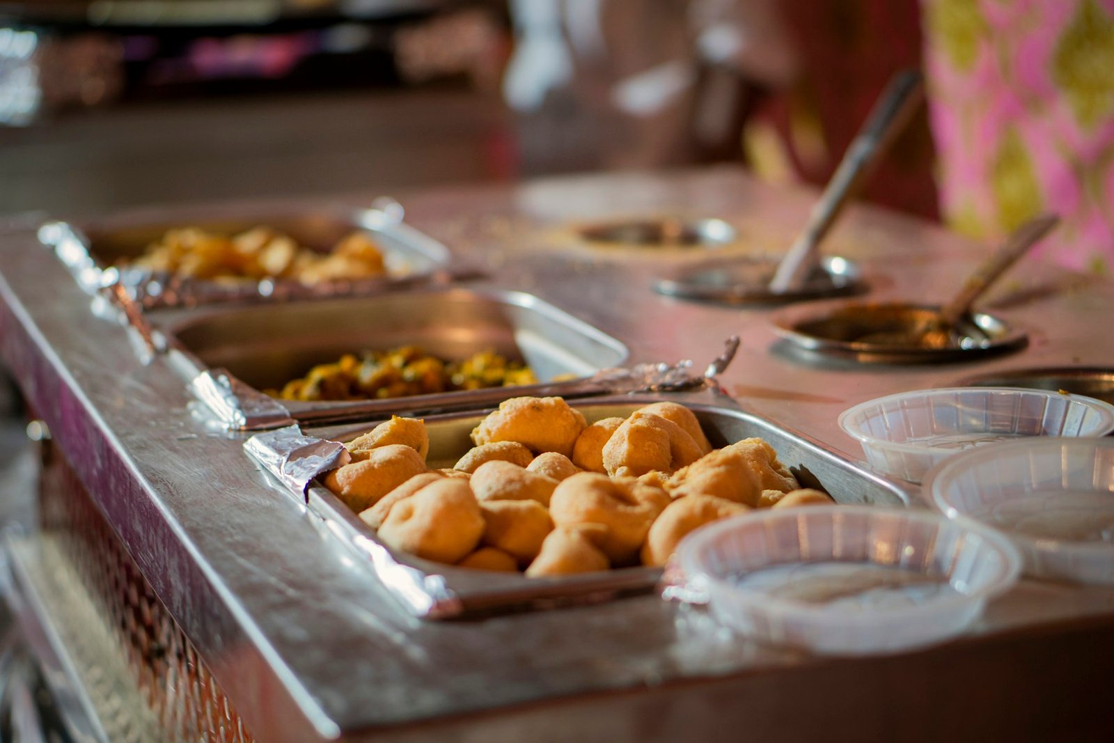 Wedding catering spread of Indian sweets and savouries laid out for guests