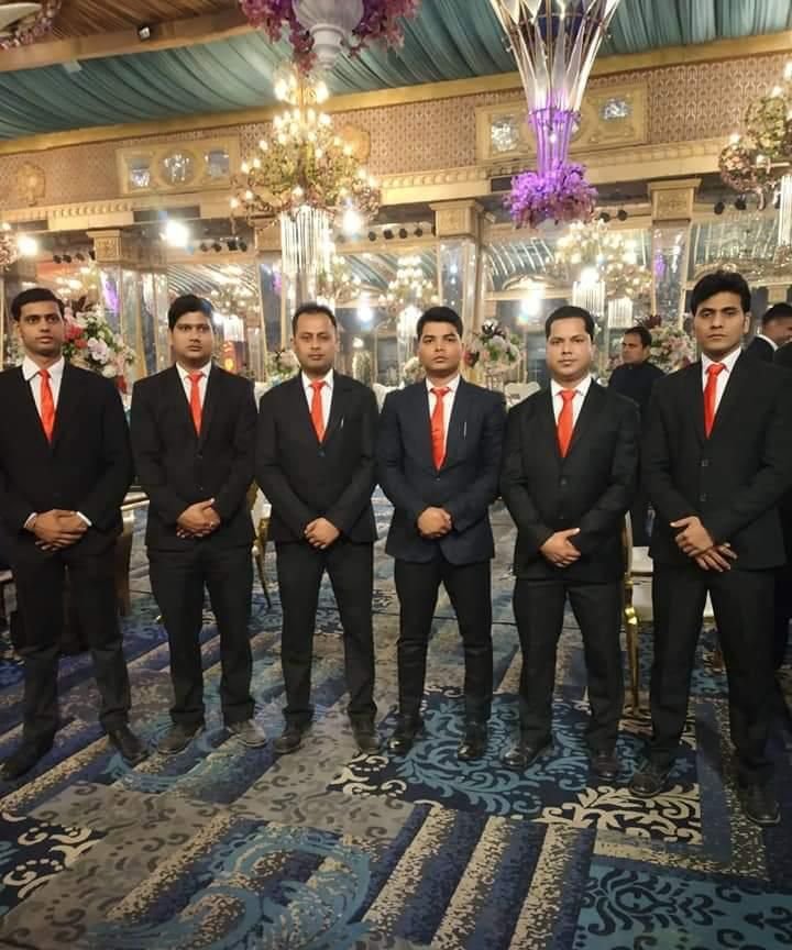 Catering supervisors in suits on duty at a banquet hall